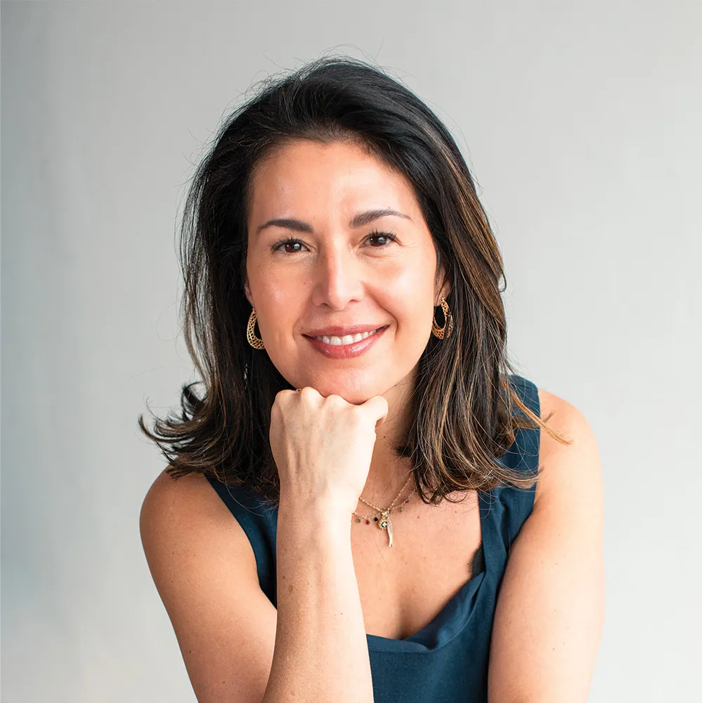 A woman smiling confidently, embodying the personalized and intentional approach of Refine Aesthetics in Colorado Springs.
