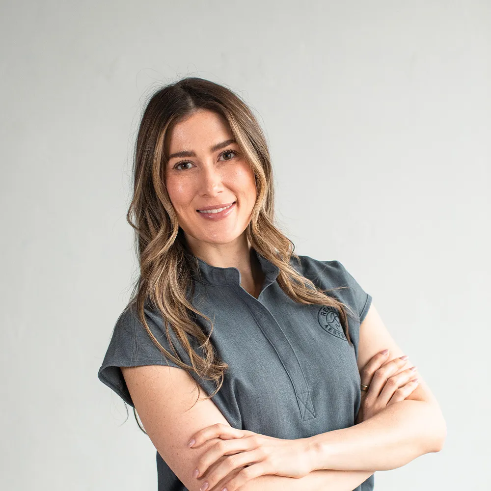 Smiling professional at Refine Aesthetics, a Colorado Springs medical aesthetics clinic.