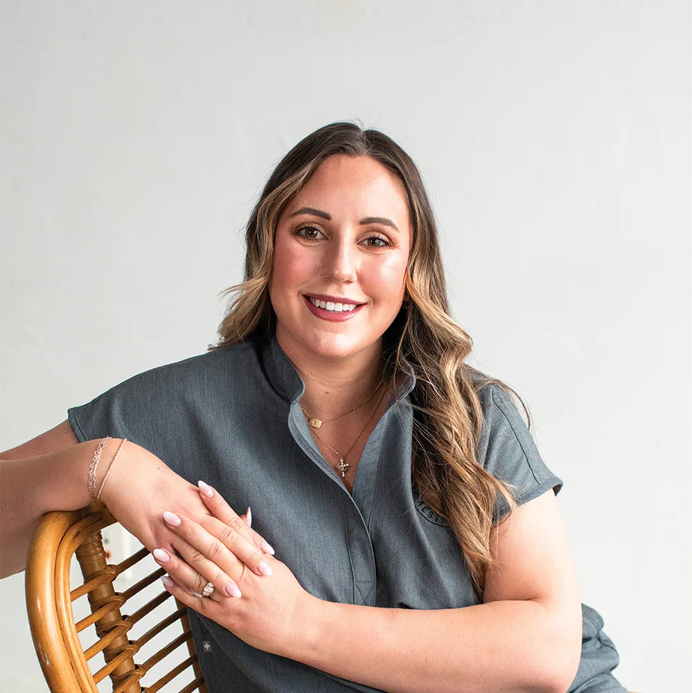 Smiling staff member at Refine Aesthetics in Colorado Springs.