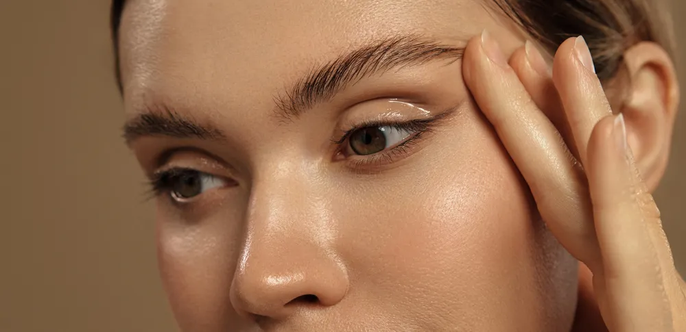 Close-up of a woman's face focusing on smooth skin and raised eyebrow, related to personalized aesthetics services in Colora…